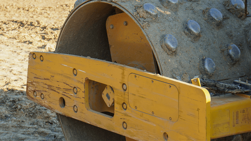 A Close Up Of A Heavy Duty Vibratory Roller Used For Compacting Sandy Soil Jpg