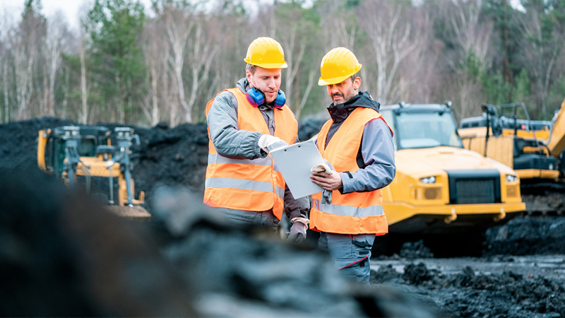 Excavation Workers Checking The Project Timeline Jpg