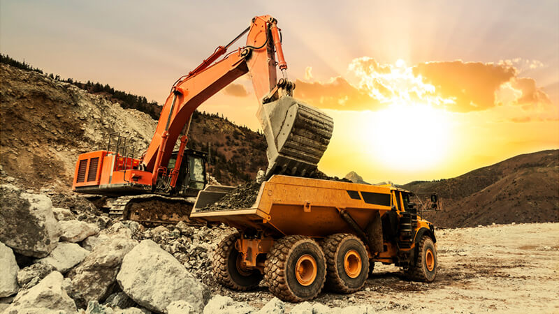 An Excavator Removing Rocks From The Site Jpg