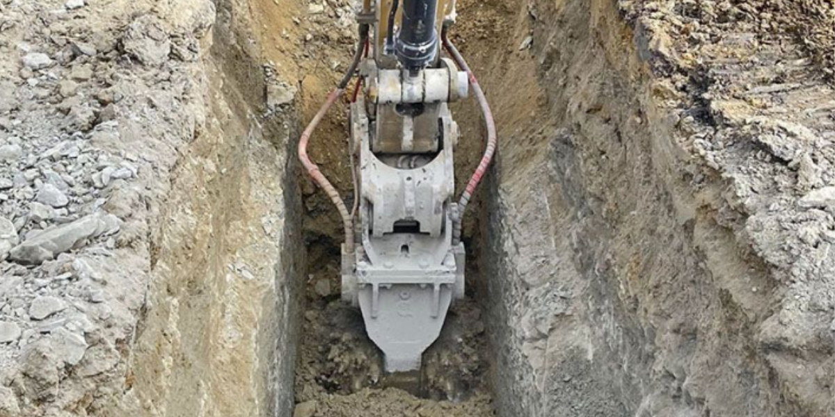 Excavator cutting a narrow trench with clean, vertical walls